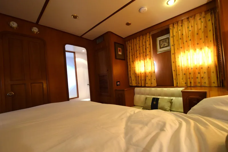 Odyssey Yacht Photos Pics Luxurious cabin interior of 2000 Trader Sunliner 625 yacht with warm wood paneling.