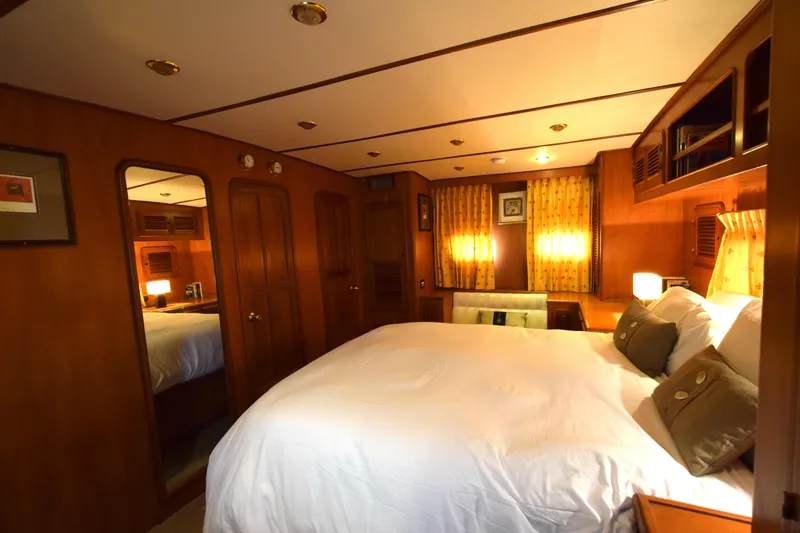 Odyssey Yacht Photos Pics Luxurious bedroom interior of 2000 Trader Sunliner 625 yacht with cozy lighting and elegant decor.