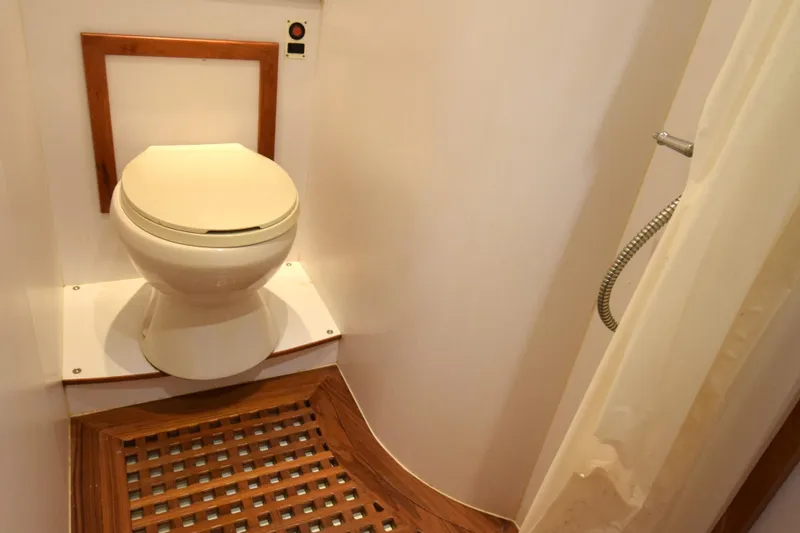 Odyssey Yacht Photos Pics Compact bathroom in 2000 Trader Sunliner 625 yacht with toilet and shower.