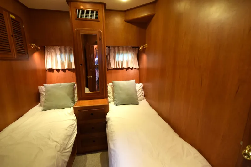 Odyssey Yacht Photos Pics Cozy twin cabin in 2000 Trader Sunliner 625 yacht with wooden interior and soft lighting.