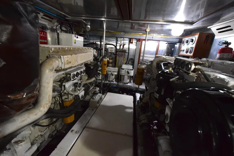Odyssey Yacht Photos Pics Engine room of 2000 Trader Sunliner 625 yacht, featuring complex machinery and equipment.