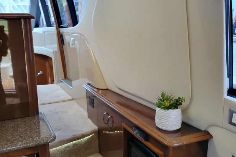  Yacht Photos Pics Interior of 2007 Carver 56 Voyager SE yacht with elegant wood finish and potted plant.
