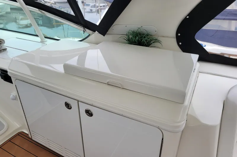  Yacht Photos Pics 2007 Carver 56 Voyager SE yacht interior with sleek white cabinetry and decorative plant.