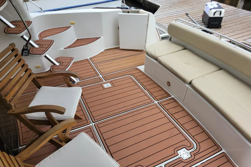  Yacht Photos Pics 2007 Carver 56 Voyager SE yacht deck with wooden chairs and cushioned seating.