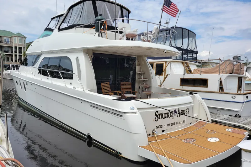  Yacht Photos Pics 2007 Carver 56 Voyager SE yacht docked, featuring spacious deck and American flag.