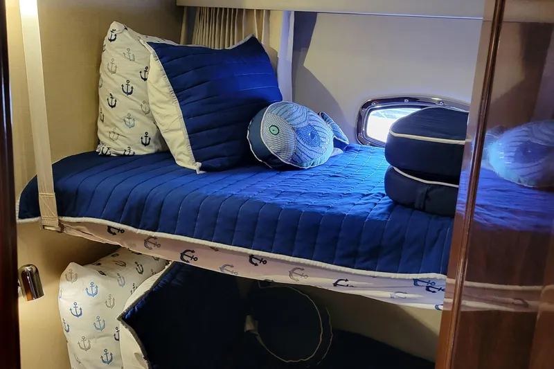  Yacht Photos Pics 2007 Carver 56 Voyager SE cabin with nautical-themed bedding and porthole window.