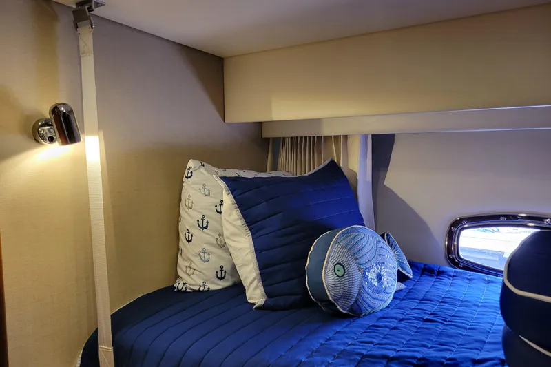  Yacht Photos Pics Cozy cabin interior of 2007 Carver 56 Voyager SE with nautical-themed bedding.