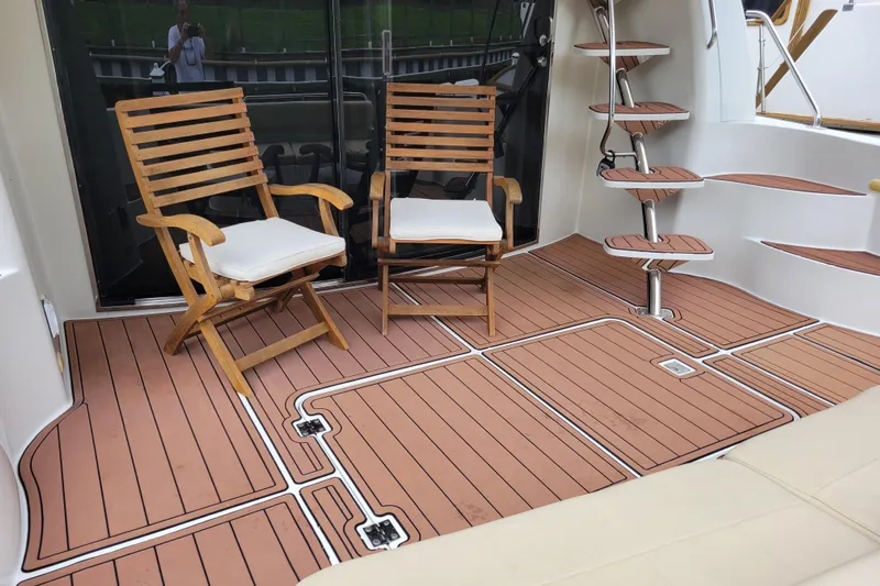  Yacht Photos Pics 2007 Carver 56 Voyager SE yacht deck with wooden chairs and spiral staircase.