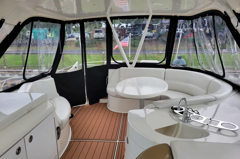  Yacht Photos Pics Luxurious 2007 Carver 56 Voyager SE yacht interior with seating and kitchenette.