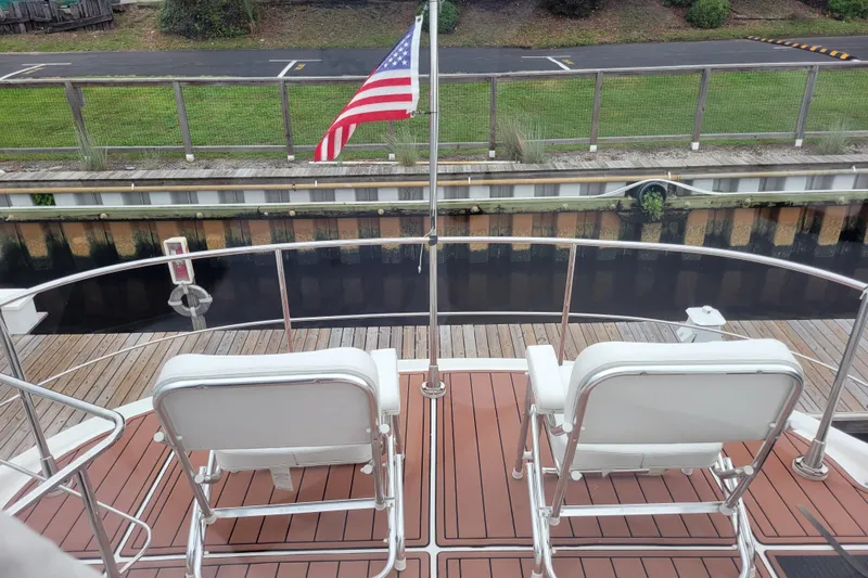  Yacht Photos Pics 2007 Carver 56 Voyager SE yacht deck with chairs and American flag.