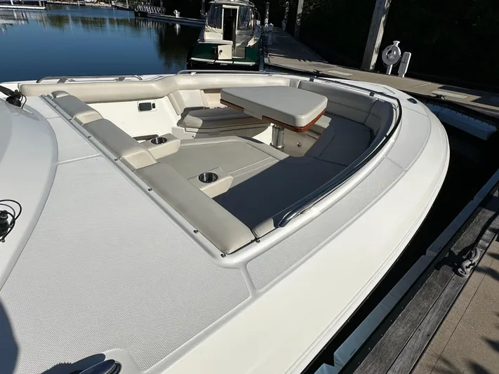 Hightide Yacht Photos Pics 2022 Boston Whaler 380 Realm boat with spacious seating and table on deck.