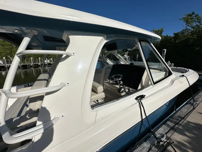 Hightide Yacht Photos Pics 2022 Boston Whaler 380 Realm boat docked, showcasing sleek design and modern features.