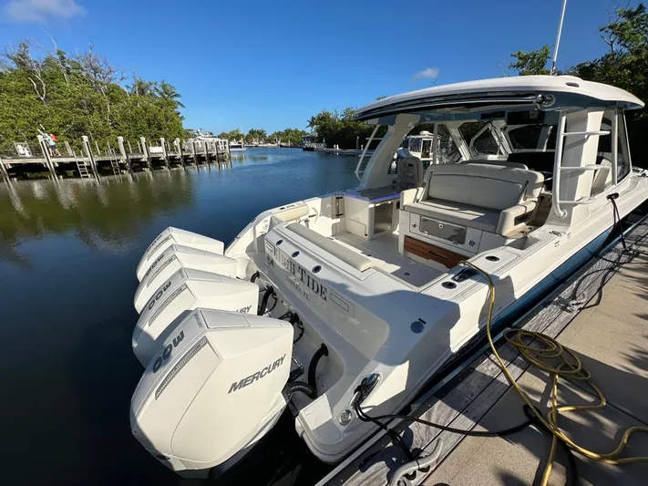 Hightide Yacht Photos Pics 2022 Boston Whaler 380 Realm docked, featuring powerful Mercury outboard engines.
