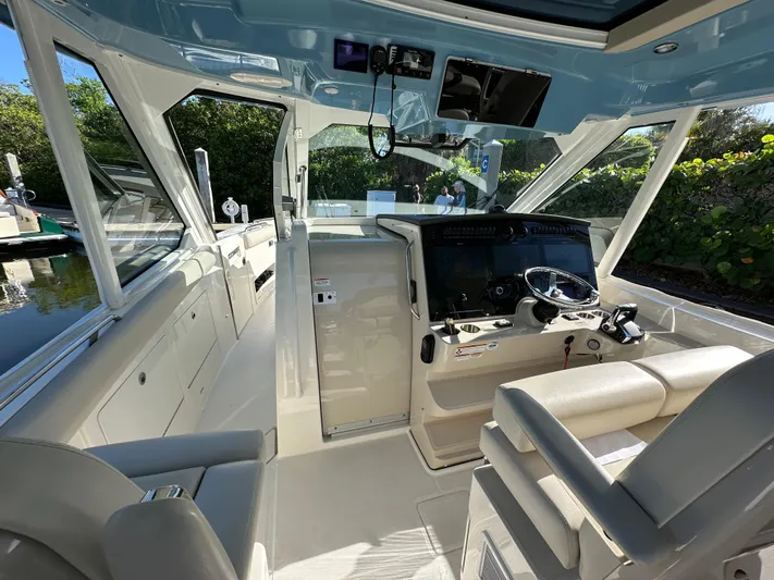Hightide Yacht Photos Pics 2022 Boston Whaler 380 Realm cockpit with modern controls and seating.