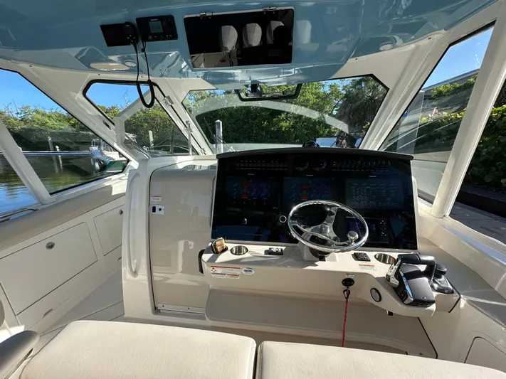 Hightide Yacht Photos Pics 2022 Boston Whaler 380 Realm cockpit with modern controls and steering wheel.