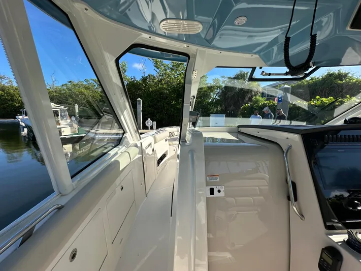 Hightide Yacht Photos Pics Interior view of 2022 Boston Whaler 380 Realm boat, showcasing helm and seating area.