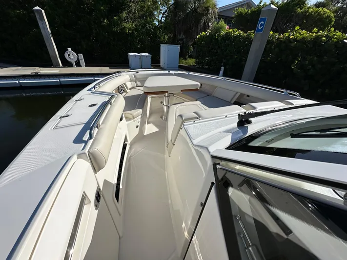 Hightide Yacht Photos Pics 2022 Boston Whaler 380 Realm boat interior with seating and table at dock.