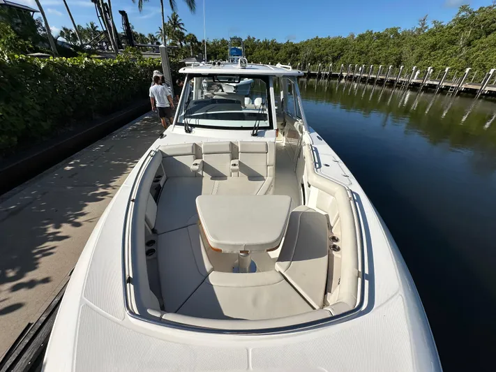 Hightide Yacht Photos Pics 2022 Boston Whaler 380 Realm boat docked, featuring spacious seating and sleek design.