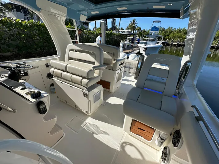 Hightide Yacht Photos Pics Interior of 2022 Boston Whaler 380 Realm boat, featuring luxurious seating and modern controls.