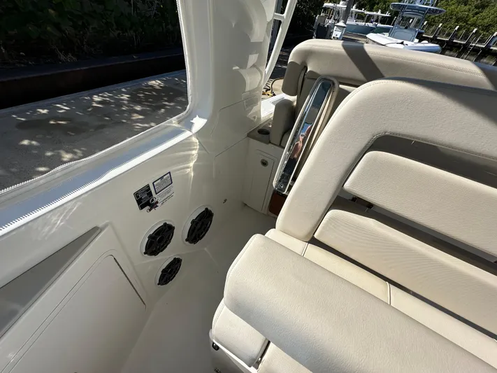 Hightide Yacht Photos Pics 2022 Boston Whaler 380 Realm interior with beige seating and speaker system.