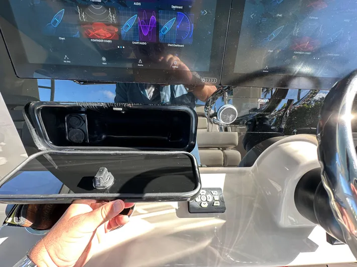 Hightide Yacht Photos Pics Dashboard of 2022 Boston Whaler 380 Realm with touchscreen controls and storage compartment.