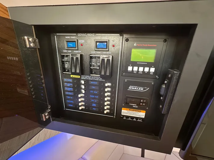 Hightide Yacht Photos Pics Electrical control panel on 2022 Boston Whaler 380 Realm boat, featuring switches and displays.