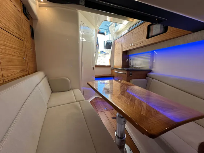 Hightide Yacht Photos Pics Interior of 2022 Boston Whaler 380 Realm with wood accents and ambient lighting.