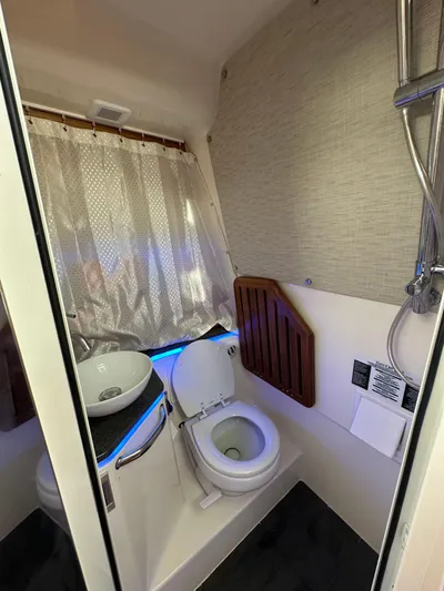 Hightide Yacht Photos Pics 2022 Boston Whaler 380 Realm bathroom with toilet, sink, and shower.