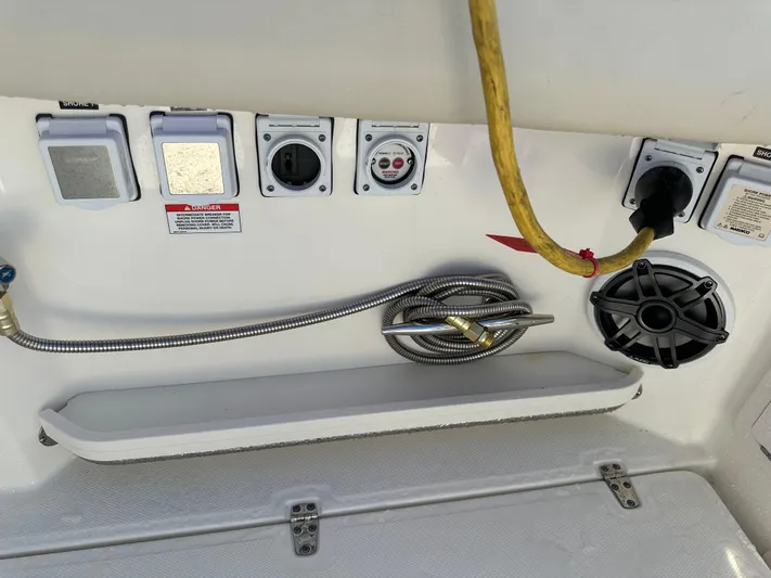 Hightide Yacht Photos Pics Boston Whaler 380 Realm 2022 boat electrical panel with shore power connections and speaker.