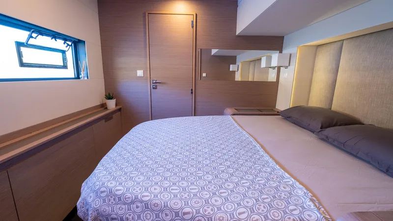  Yacht Photos Pics Luxurious bedroom interior of 2023 Fountaine Pajot Catamaran Alegria 67 with modern design.