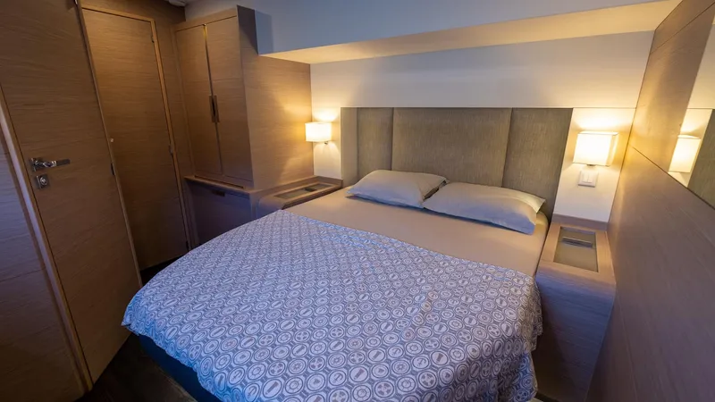  Yacht Photos Pics Luxurious bedroom interior of 2023 Fountaine Pajot Catamaran Alegria 67 with modern lighting.