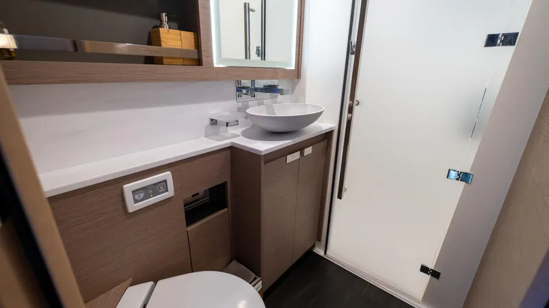  Yacht Photos Pics Modern bathroom in 2023 Fountaine Pajot Catamaran Alegria 67 with sleek fixtures and elegant design.