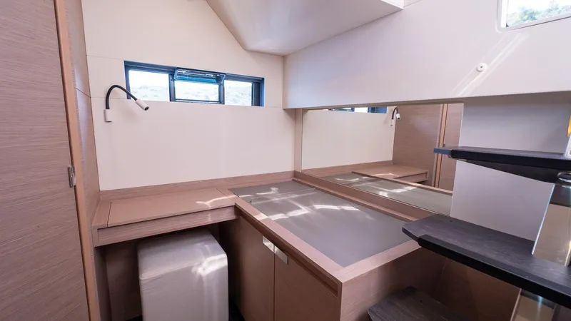  Yacht Photos Pics 2023 Fountaine Pajot Catamaran Alegria 67 interior with modern desk and storage.