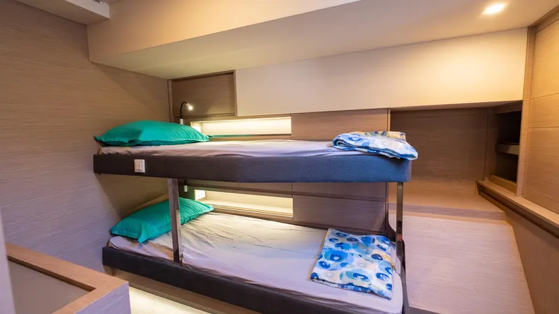  Yacht Photos Pics 2023 Fountaine Pajot Catamaran Alegria 67 cabin with bunk beds and modern lighting.