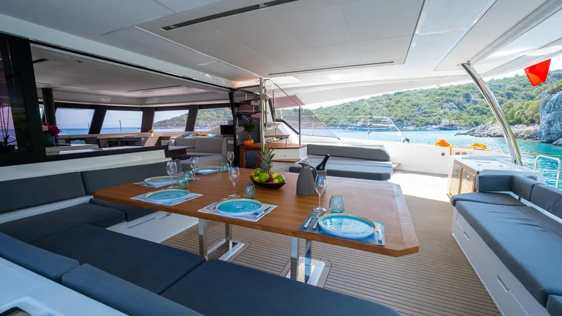  Yacht Photos Pics Luxurious 2023 Fountaine Pajot Catamaran Alegria 67 interior with elegant dining setup.