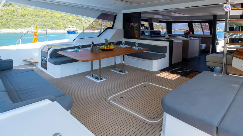  Yacht Photos Pics Luxurious interior of 2023 Fountaine Pajot Catamaran Alegria 67 with elegant seating and dining area.