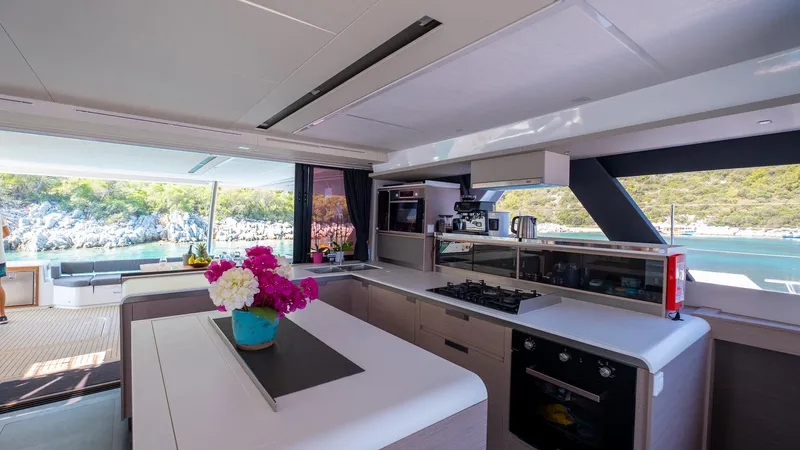  Yacht Photos Pics Luxurious interior of 2023 Fountaine Pajot Catamaran Alegria 67 with modern kitchen amenities.