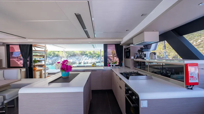  Yacht Photos Pics Luxurious kitchen interior of 2023 Fountaine Pajot Catamaran Alegria 67 with modern amenities.