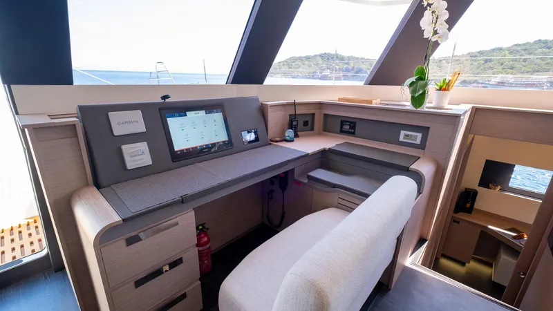  Yacht Photos Pics Modern navigation station on 2023 Fountaine Pajot Catamaran Alegria 67 with scenic ocean view.