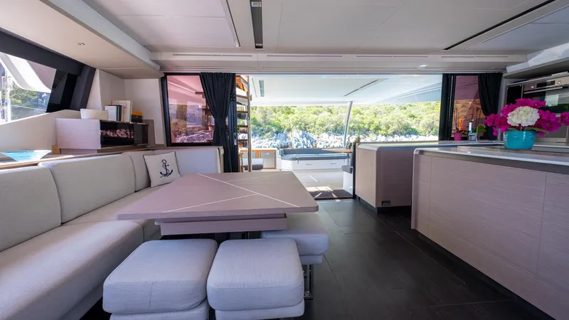  Yacht Photos Pics Luxurious interior of 2023 Fountaine Pajot Catamaran Alegria 67 with modern seating and ocean view.