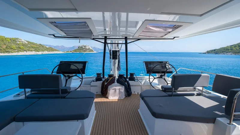  Yacht Photos Pics 2023 Fountaine Pajot Catamaran Alegria 67, luxurious deck view, serene blue waters.