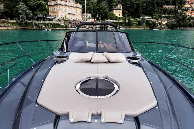  Yacht Photos Pics 2025 Cranchi Z35 yacht with sunbathing deck on tranquil water, scenic backdrop.
