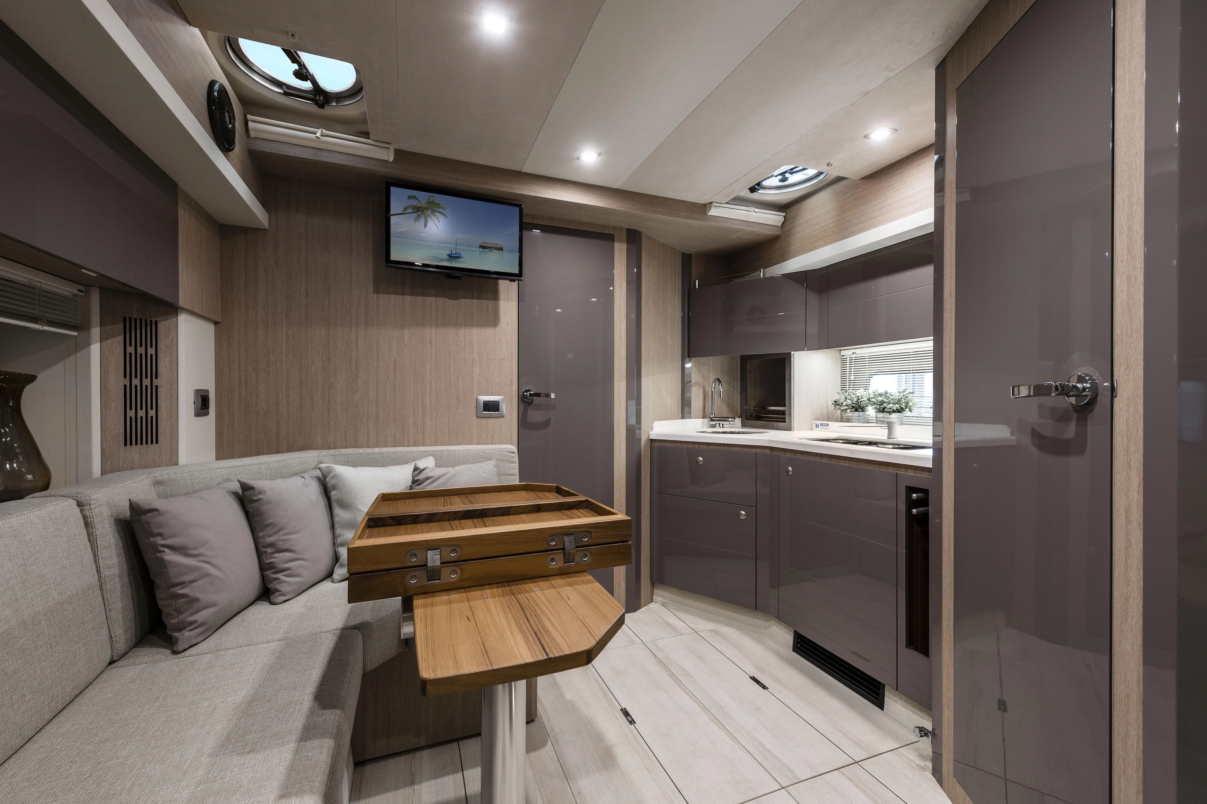  Yacht Photos Pics Luxurious interior of 2025 Cranchi Z35 yacht with modern kitchen and cozy seating area.