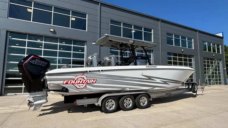  Yacht Photos Pics 2025 Fountain 34 SC boat on trailer outside modern building.