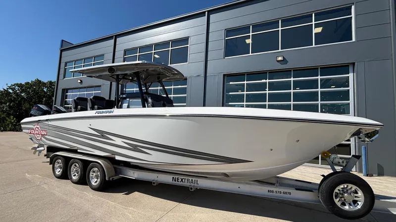  Yacht Photos Pics 2025 Fountain 34 SC boat on trailer outside modern building.