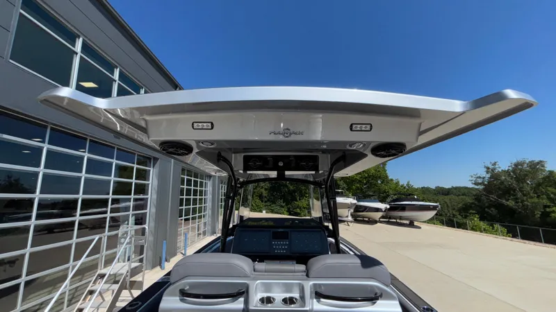  Yacht Photos Pics 2025 Fountain 34 SC boat with sleek design and advanced features, docked near a modern building.