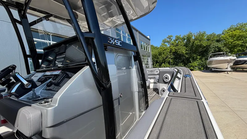  Yacht Photos Pics 2025 Fountain 34 SC boat dashboard and exterior view in a marina setting.
