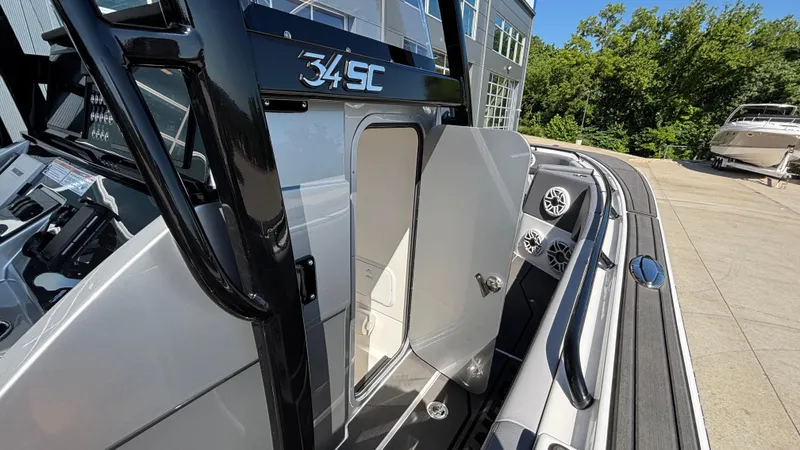  Yacht Photos Pics 2025 Fountain 34 SC boat with open cabin door and sleek design.