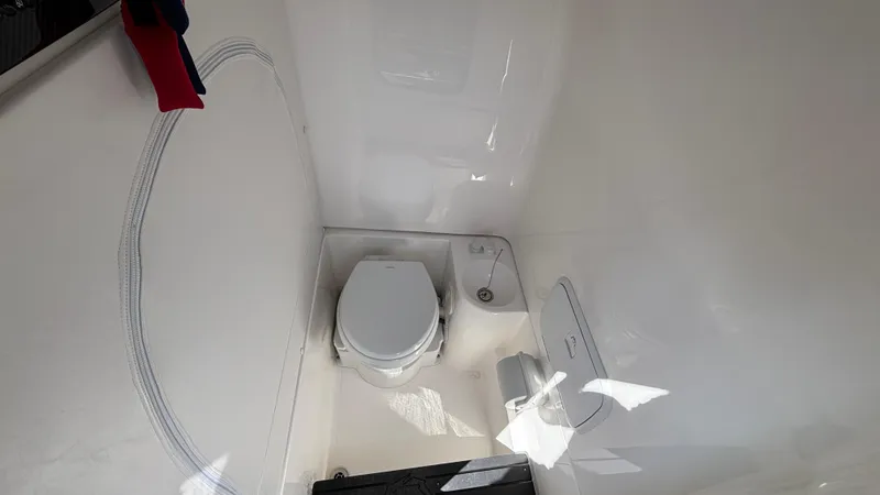  Yacht Photos Pics 2025 Fountain 34 SC boat interior with modern white bathroom and toilet.