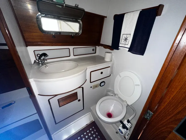  Yacht Photos Pics 1990 Little Harbor Express 36 yacht bathroom with sink, toilet, and wooden accents.